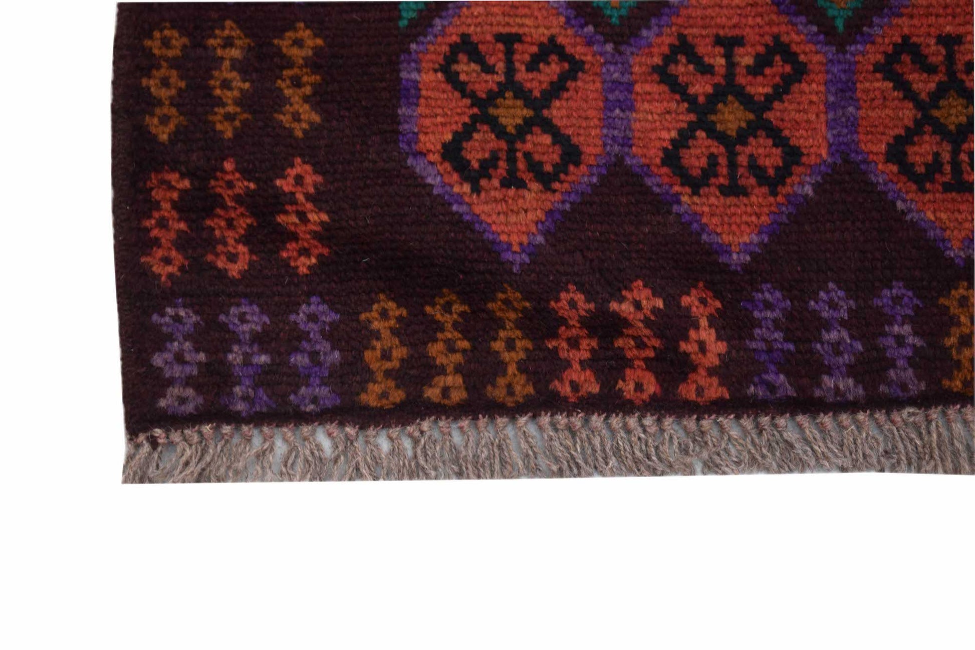 A handmade Afghan Pashm rug featuring geometric patterns in dark red, brown, and purple tones.