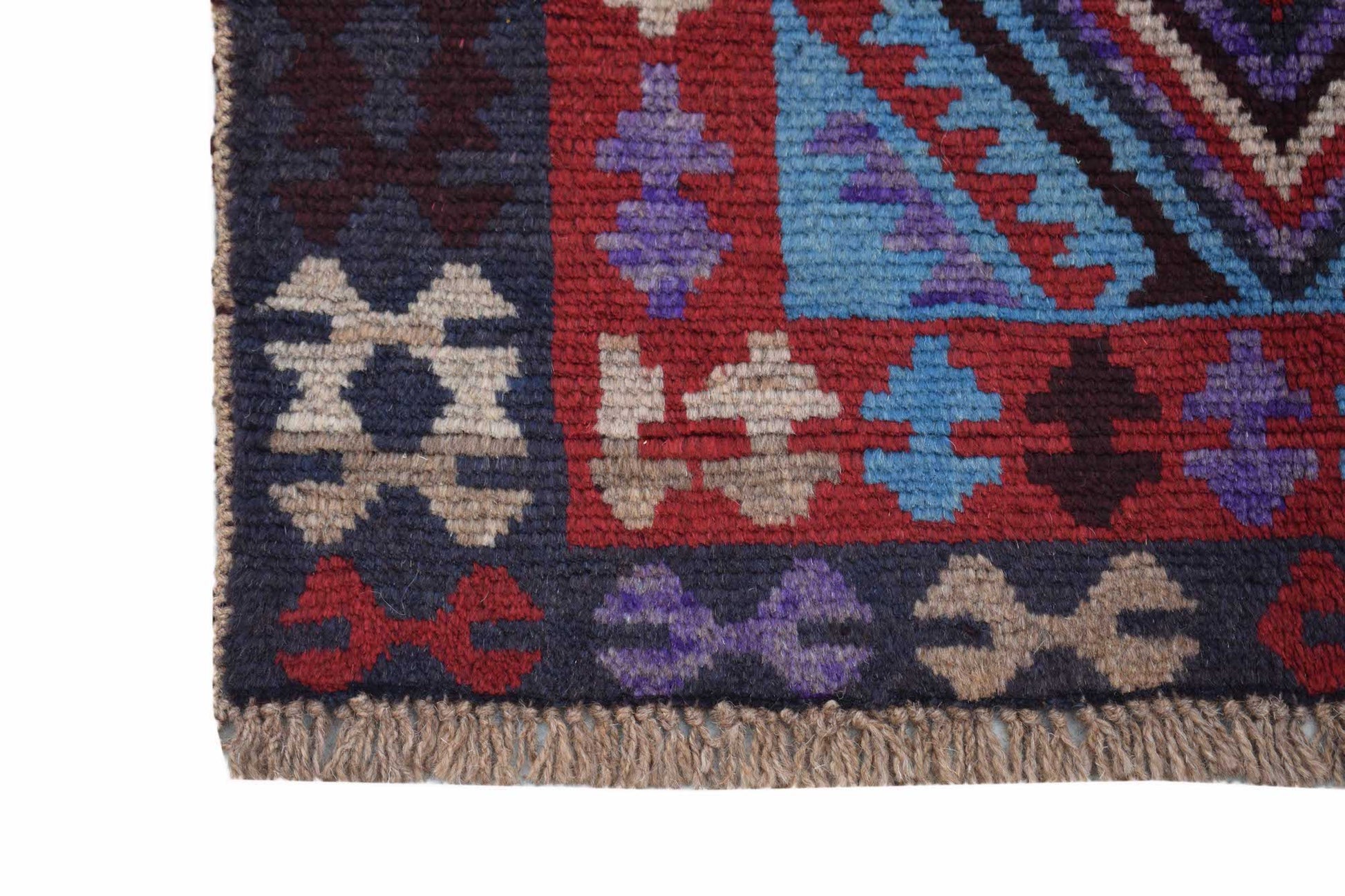 A handmade Afghan Pashm rug featuring geometric tribal patterns in red, blue, and dark brown.