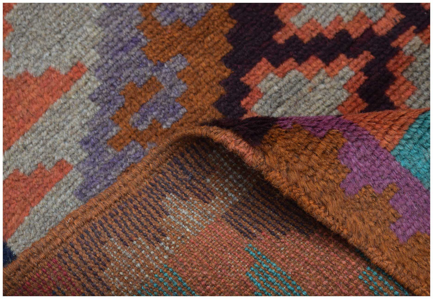 A handmade Afghan Pashm rug featuring a geometric tribal pattern in shades of orange, purple, and blue.