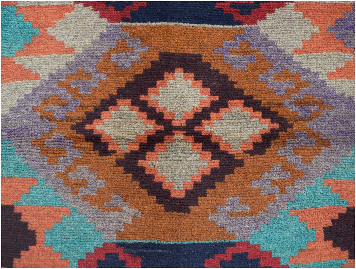 Handmade Afghan Pashm rug featuring a geometric tribal pattern in shades of orange, blue, and brown.