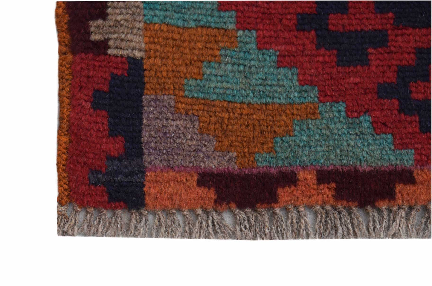 A handmade Afghan Pashm rug featuring a geometric tribal pattern in deep red, blue, and brown tones.