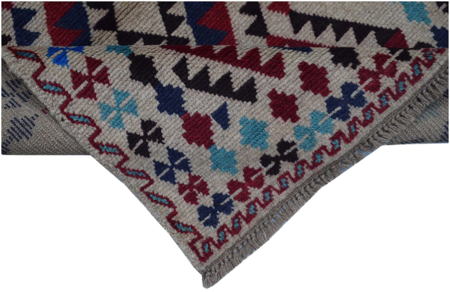 Handmade Afghan Pashm rug featuring a geometric tribal pattern in red, blue, and ivory wool.