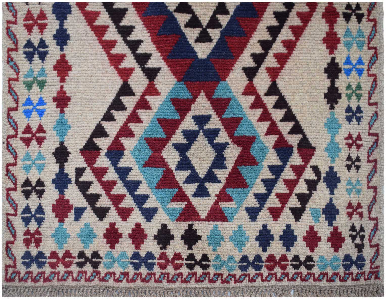 Handmade Afghan Pashm rug featuring a geometric tribal pattern in red, blue, and ivory wool.