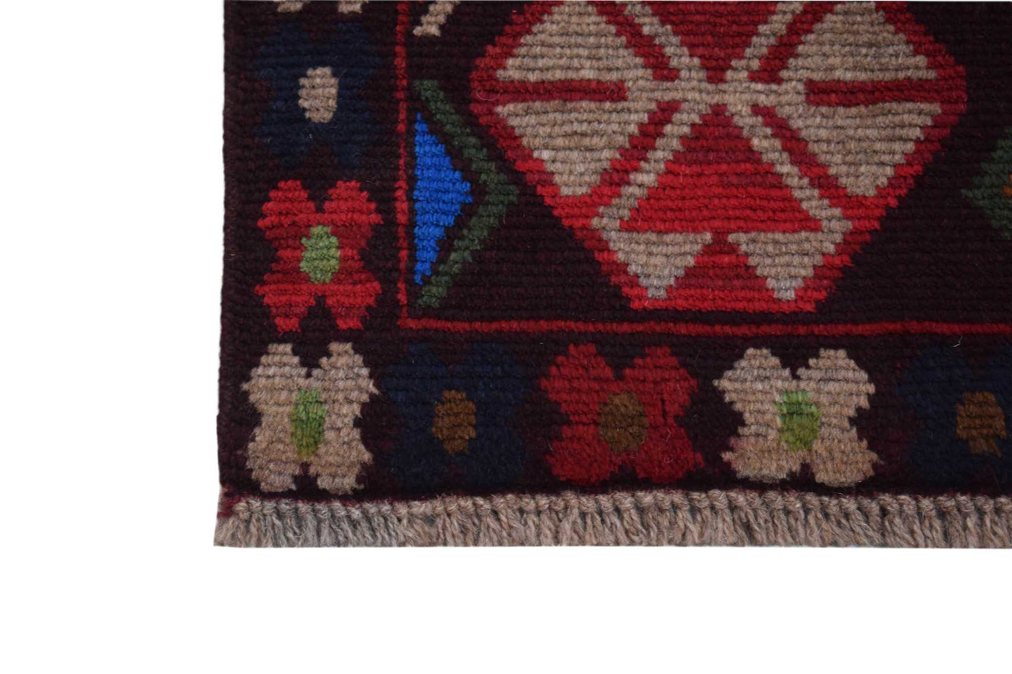 A handmade Afghan Pashm rug featuring a dark red, brown, and blue geometric pattern with fringe.