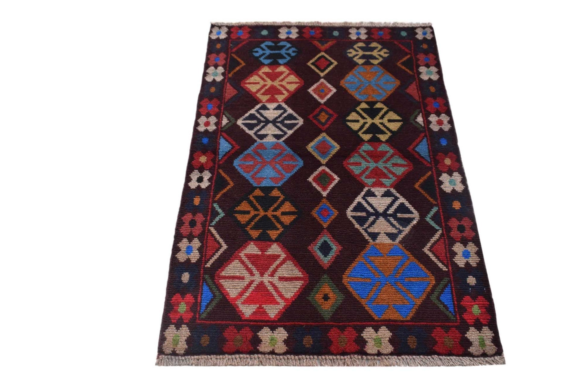 Handmade Afghan Pashm rug featuring geometric tribal patterns in dark red, blue, and brown tones.