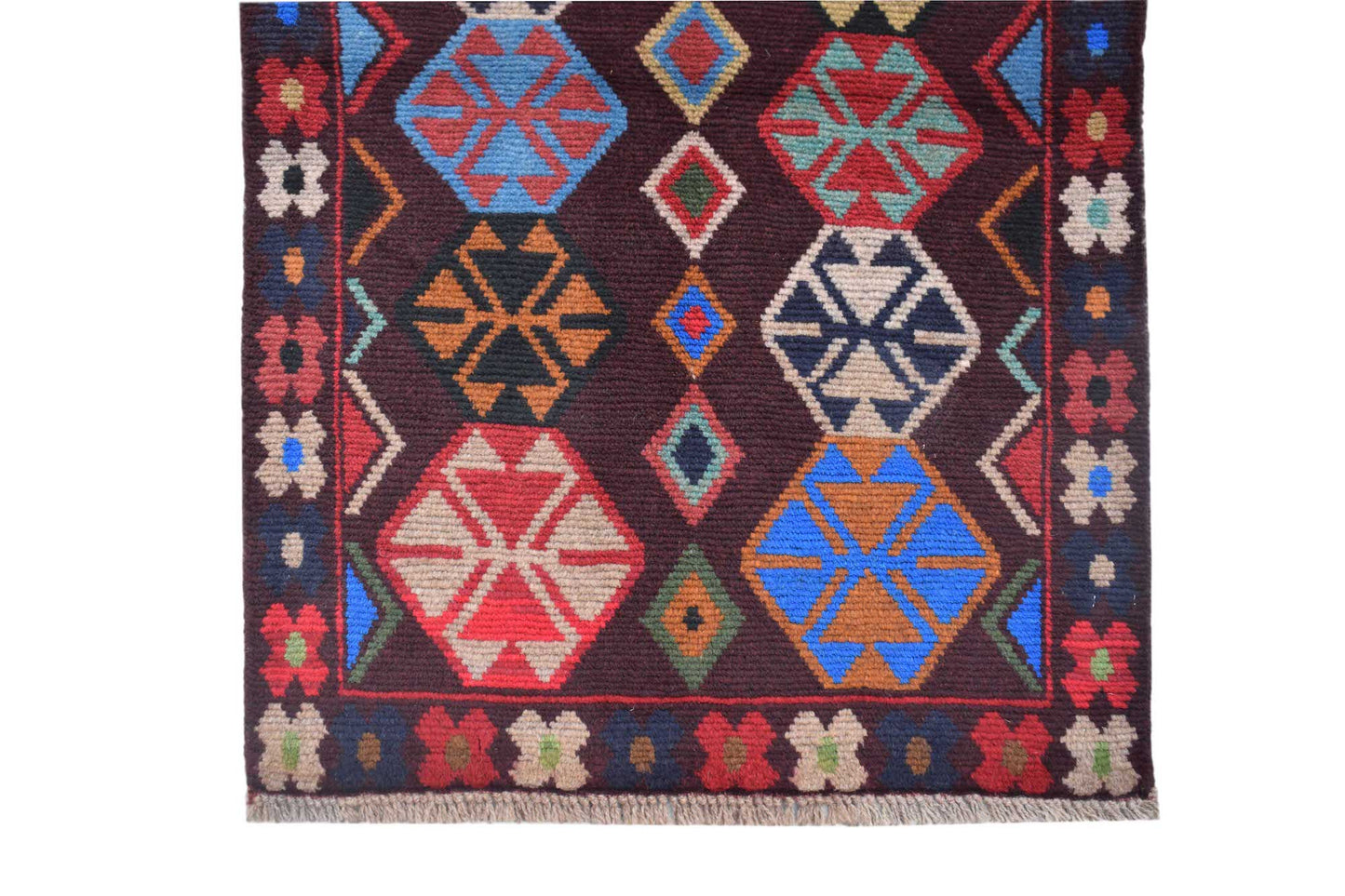 Handmade Afghan Pashm rug featuring geometric tribal patterns in dark red, blue, and brown wool.