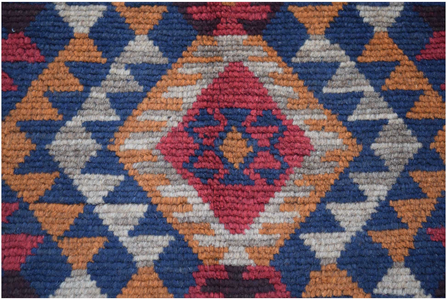 Handmade Afghan Pashm rug featuring a geometric diamond pattern in red, blue, and ivory wool.