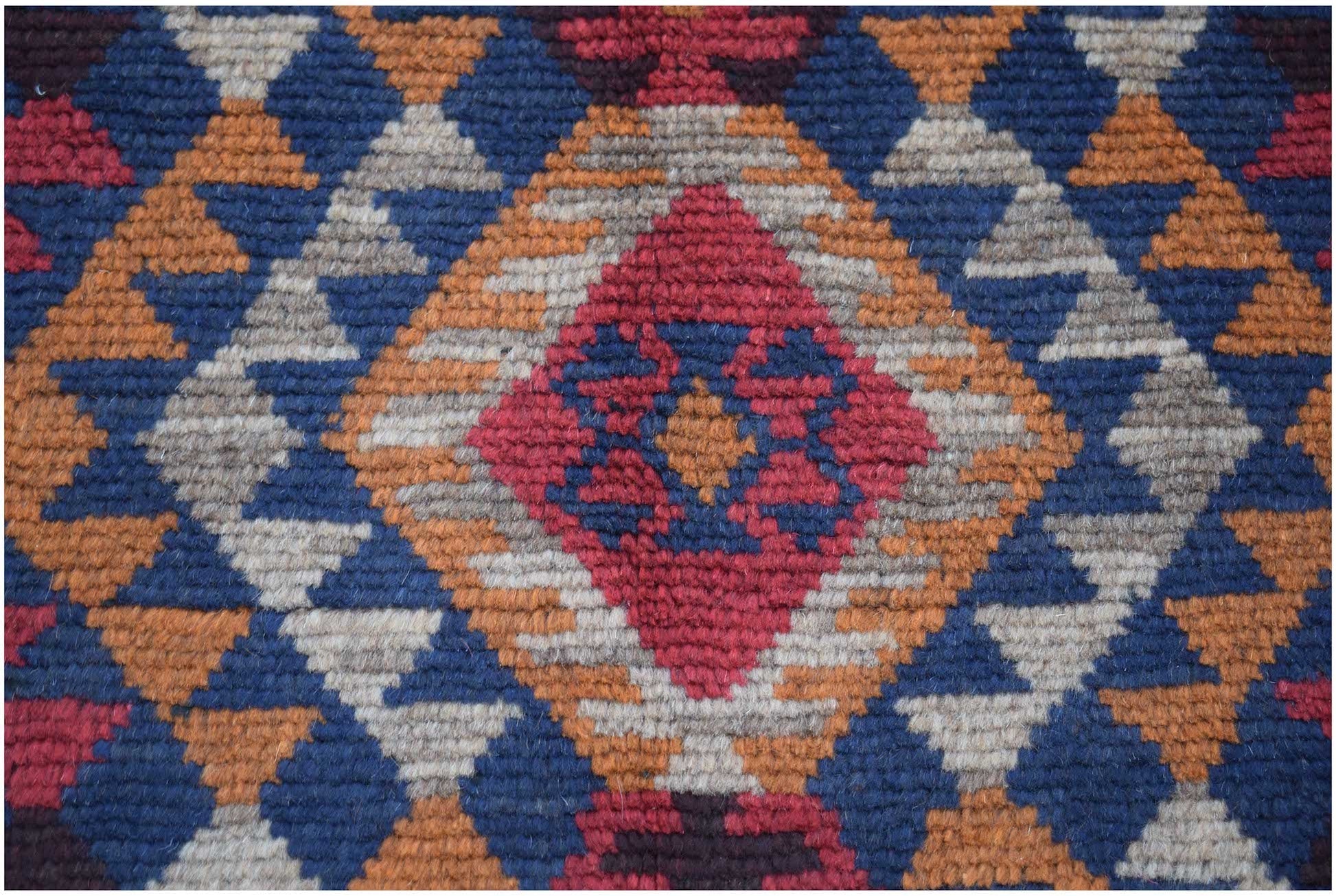 Handmade Afghan Pashm rug featuring a geometric diamond pattern in red, blue, and ivory wool.