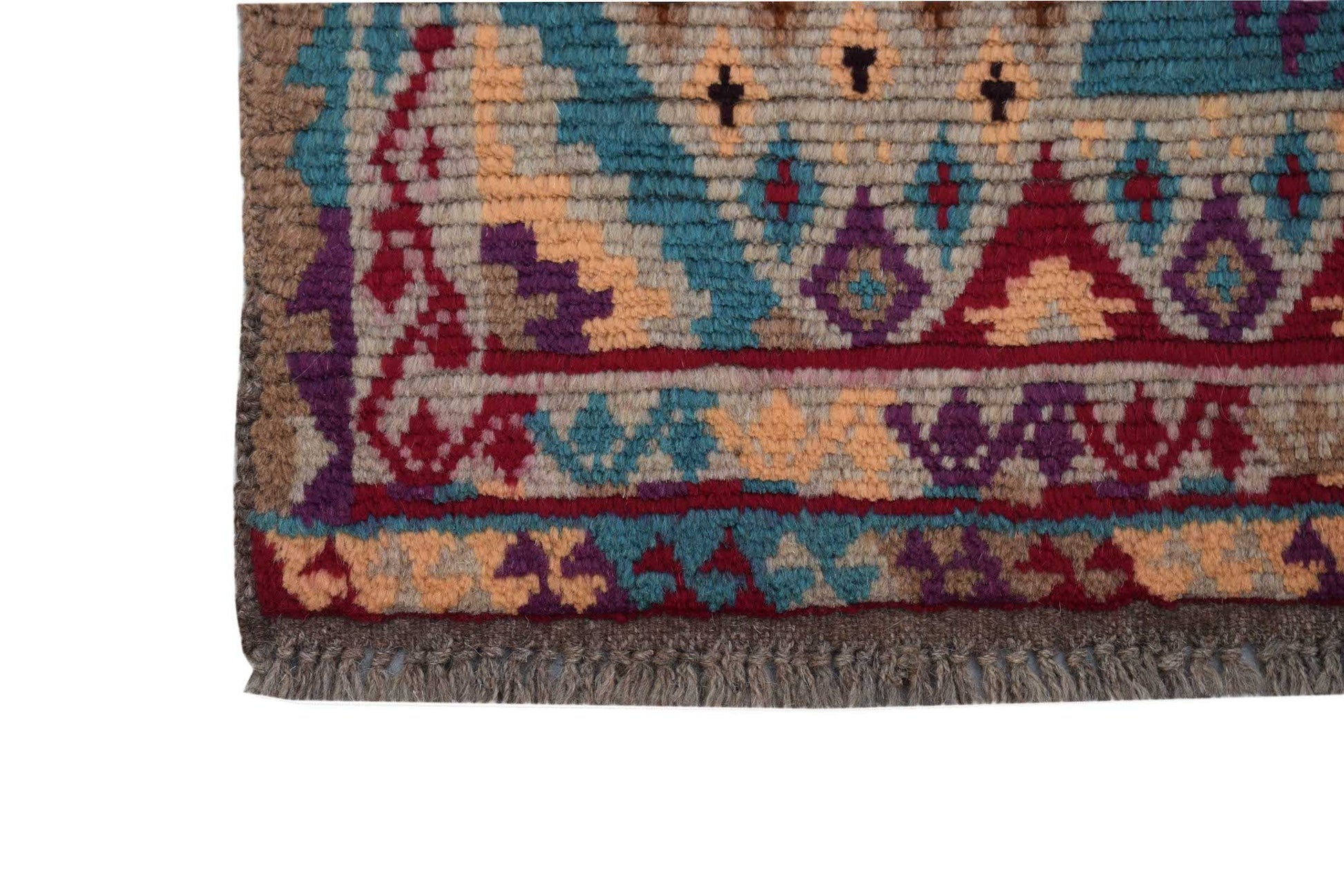 A handmade Afghan Pashm rug featuring a tribal geometric pattern in shades of red, blue, and brown.