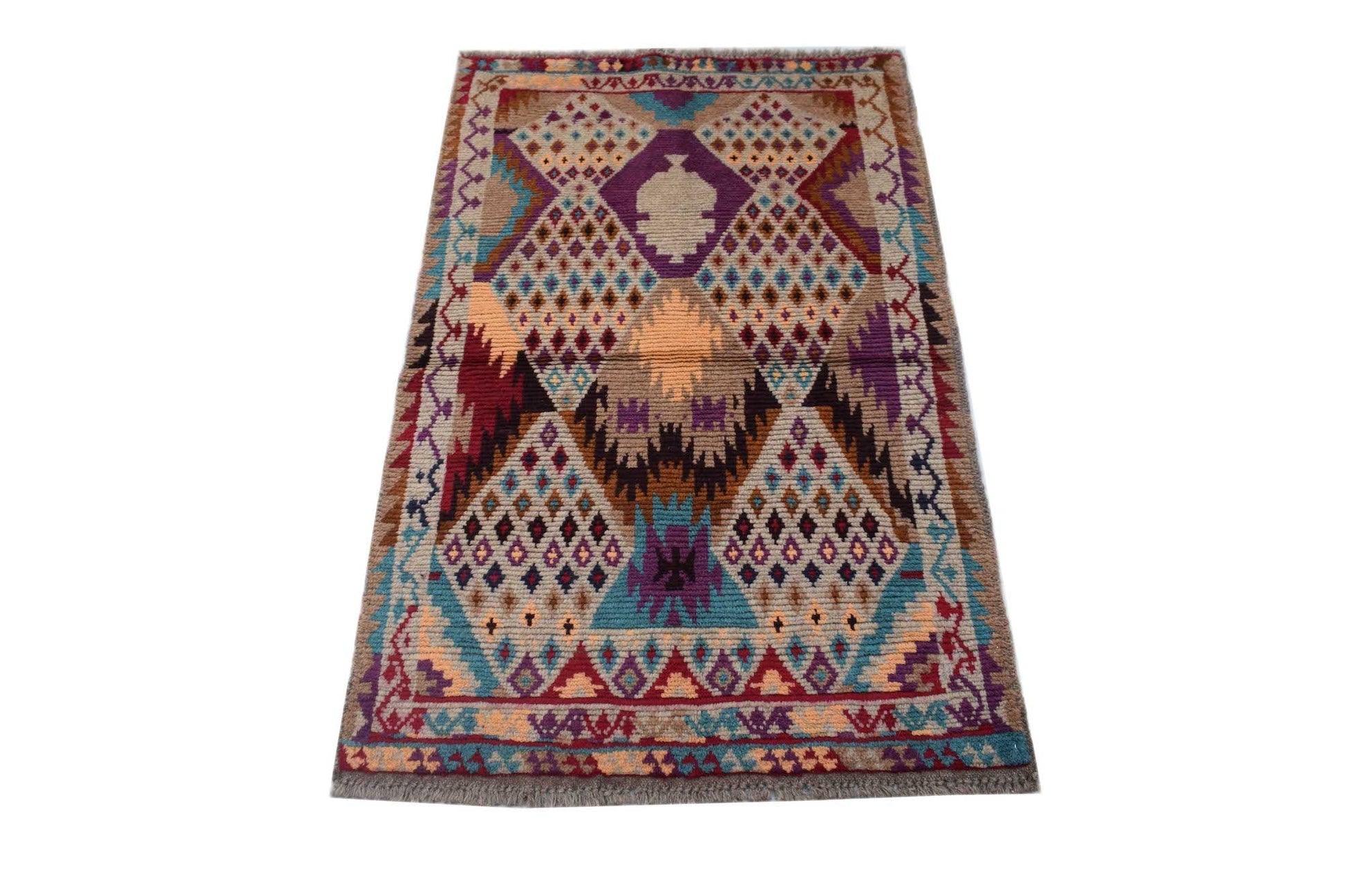 Handmade Afghan Pashm rug featuring a geometric tribal pattern in shades of red, blue, and brown.