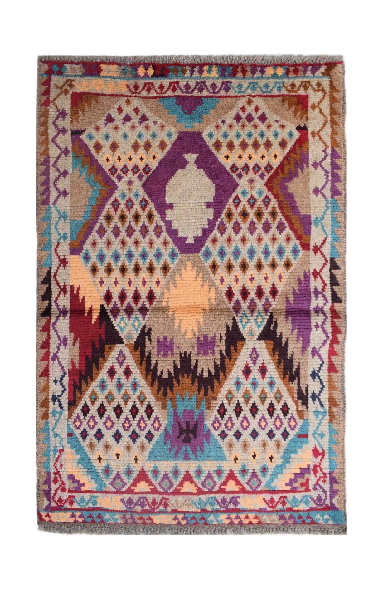Handmade Afghan Pashm rug featuring a geometric tribal pattern in vibrant multicolored wool.