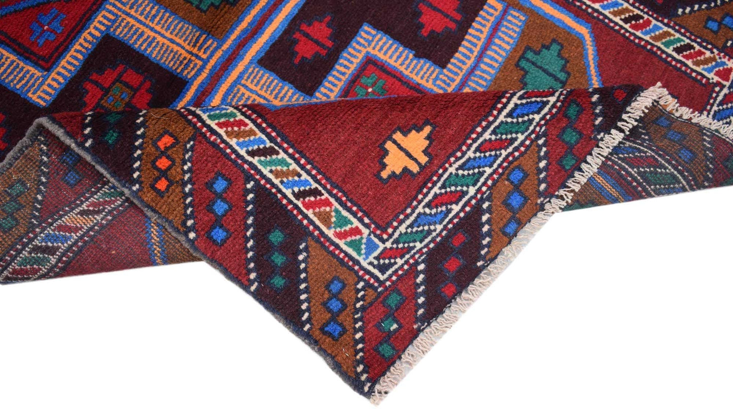 A handmade Afghan Pashm rug featuring traditional geometric patterns in deep red, blue, and brown.