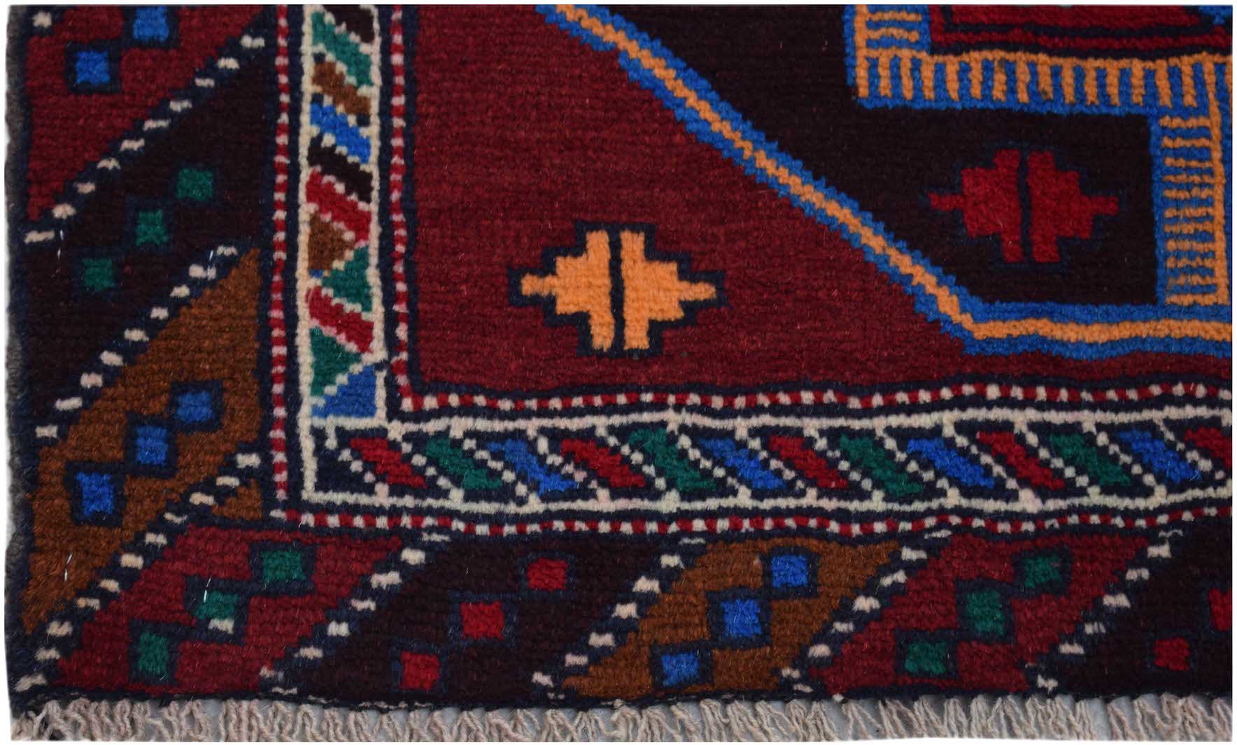 A handmade Afghan Pashm rug featuring geometric tribal patterns in deep red, blue, and brown tones.