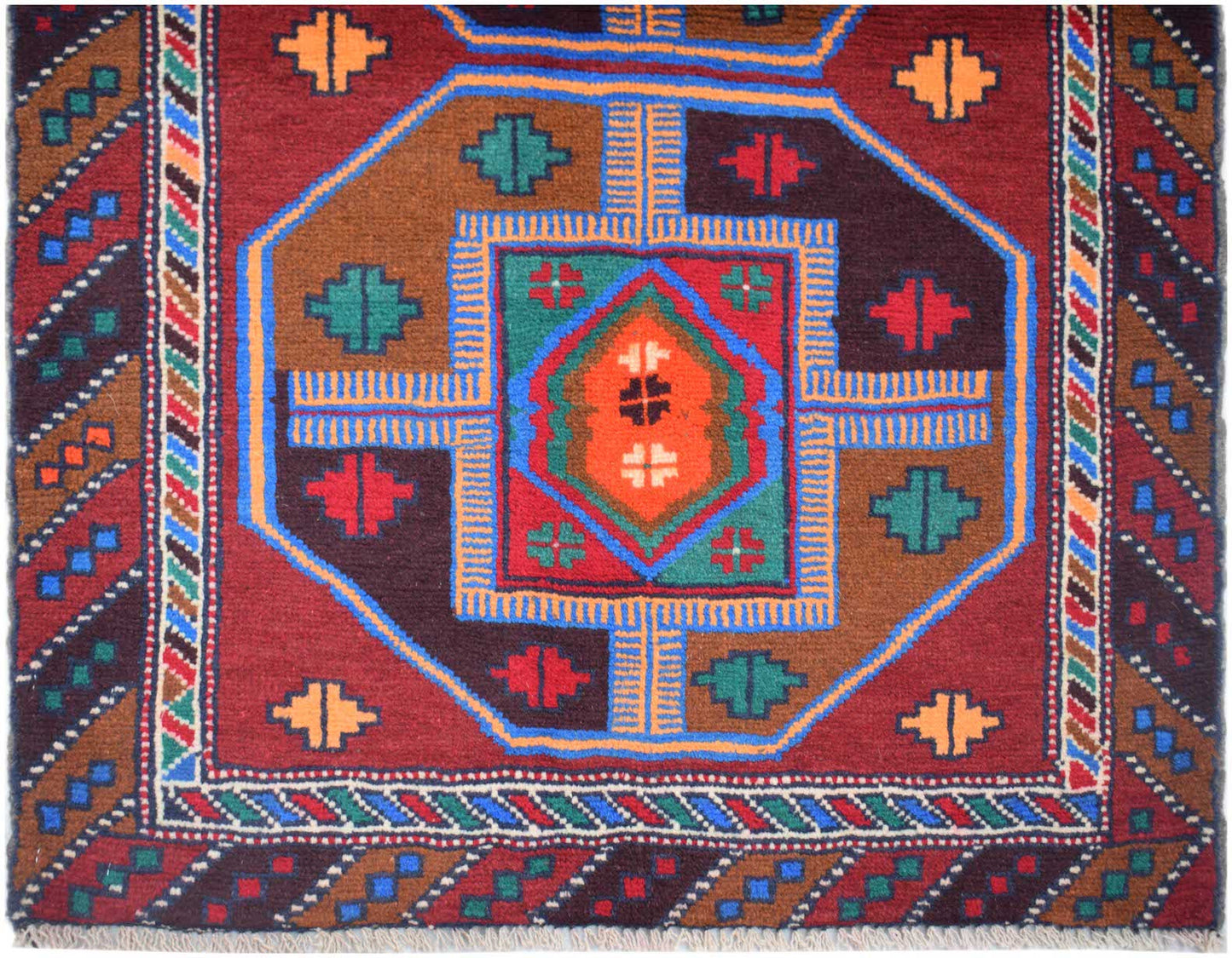 Handmade Afghan Pashm rug featuring a geometric tribal pattern in red, brown, and blue wool.