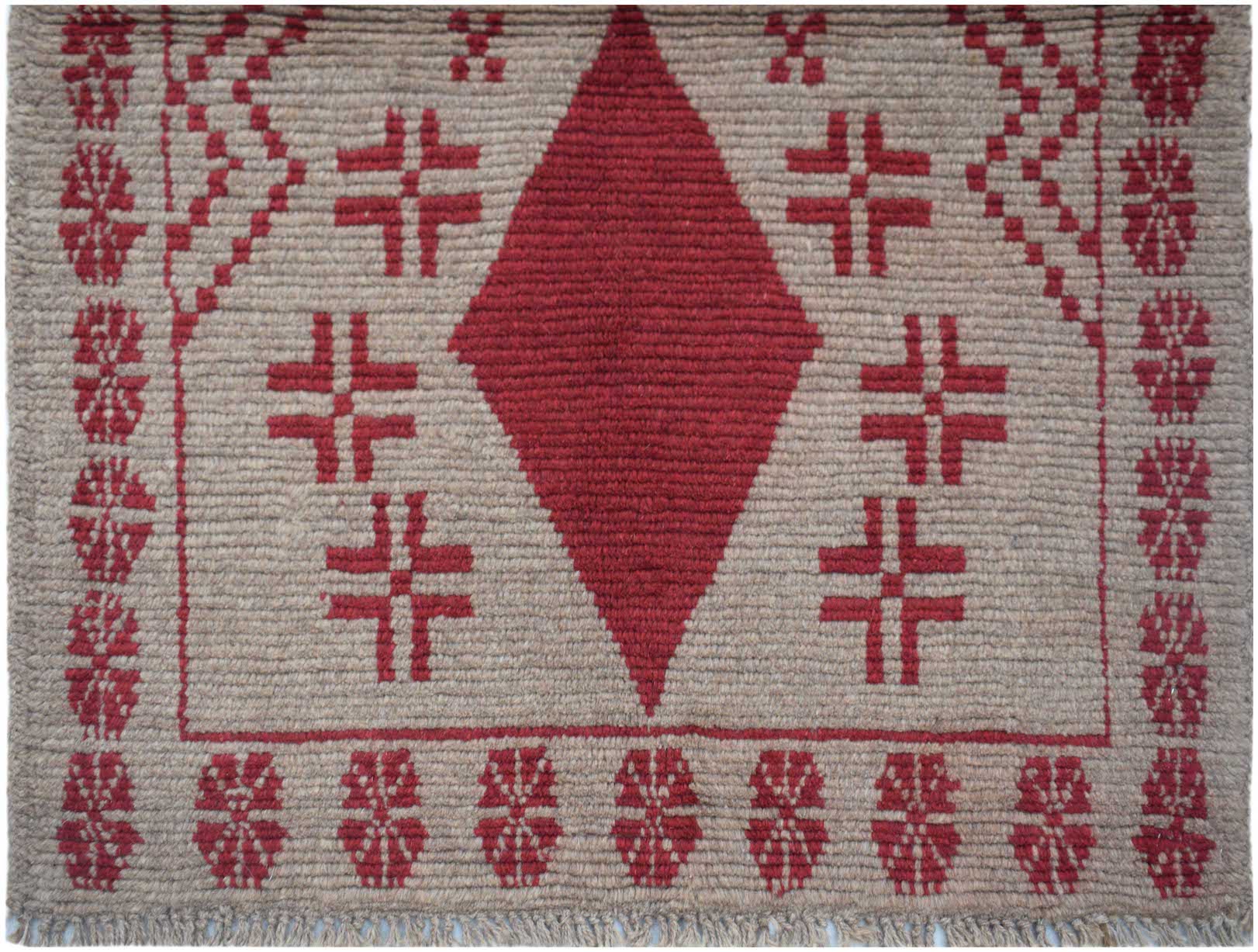 Handmade Afghan Pashm rug featuring a central red diamond motif on a tan wool background.