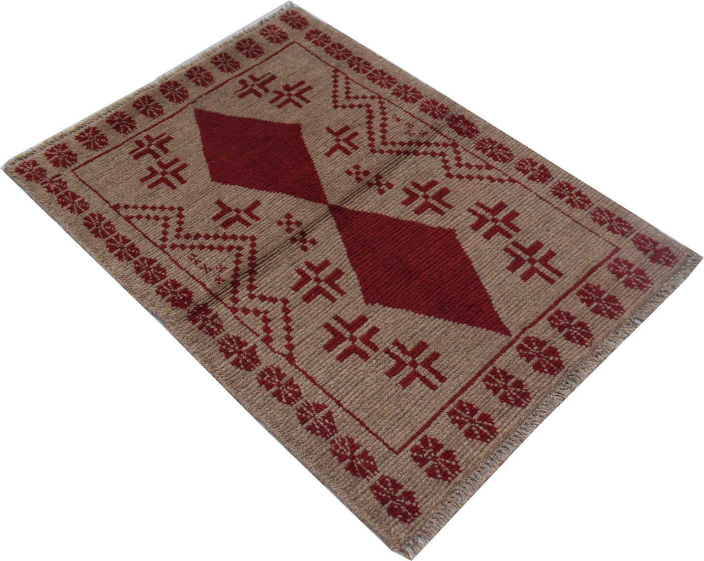 A handmade Afghan Pashm rug featuring a geometric diamond pattern in deep red on a tan background.