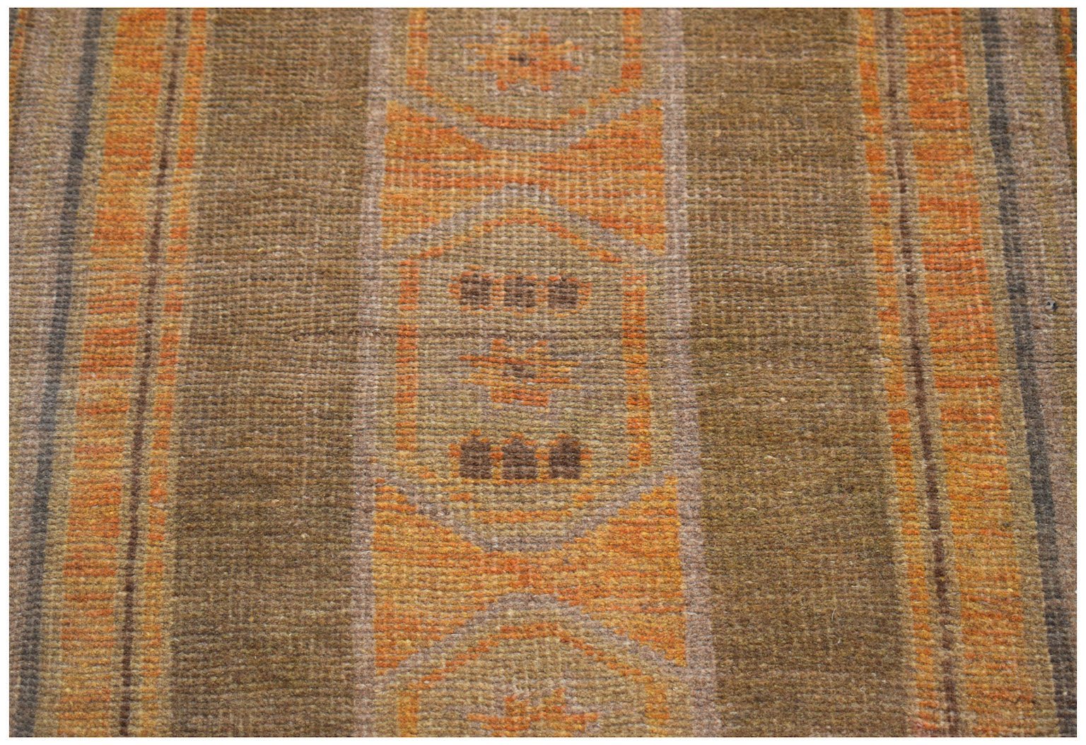 Handmade Afghan Baluch rug featuring geometric patterns in shades of brown and orange.