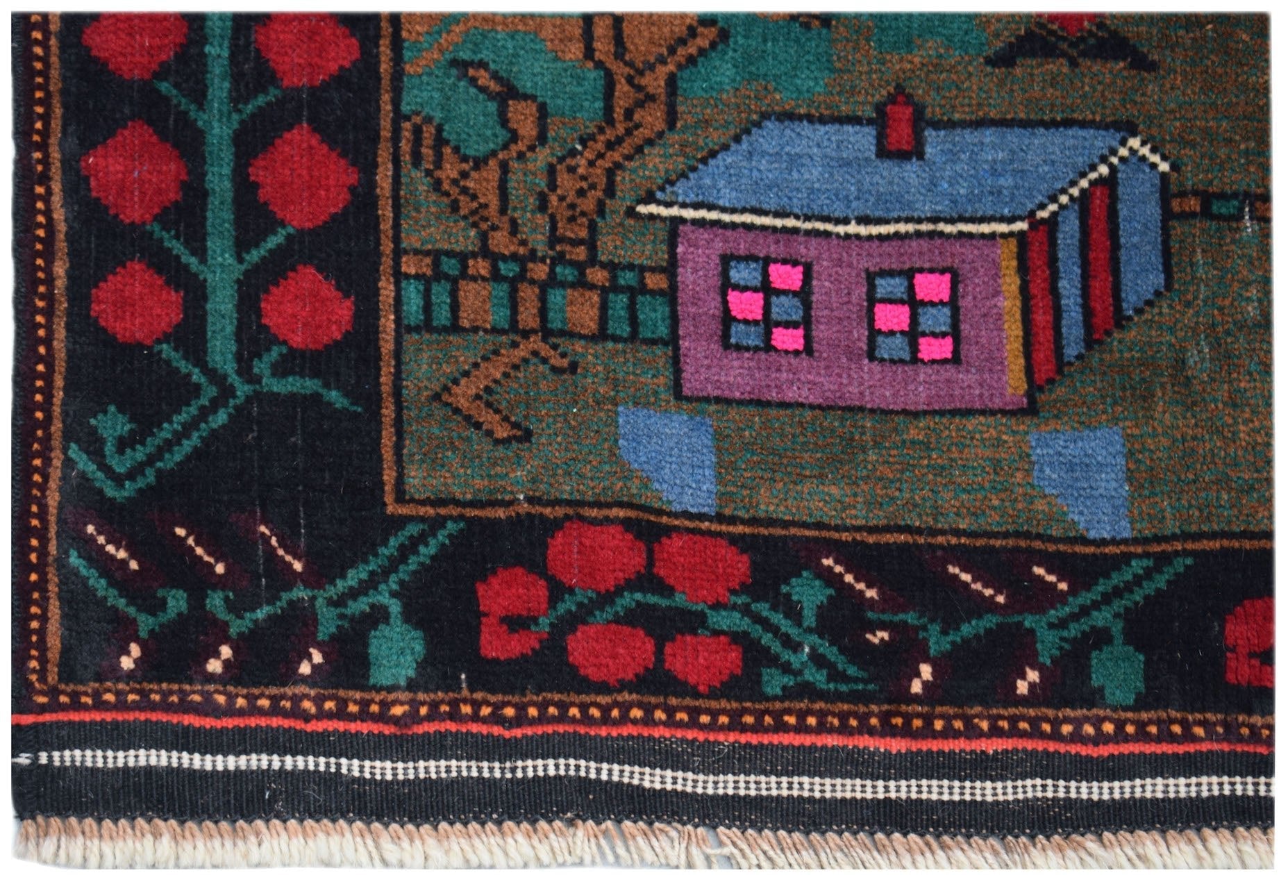 A handmade Afghan Baluch rug featuring a house motif with red floral borders on a dark background.