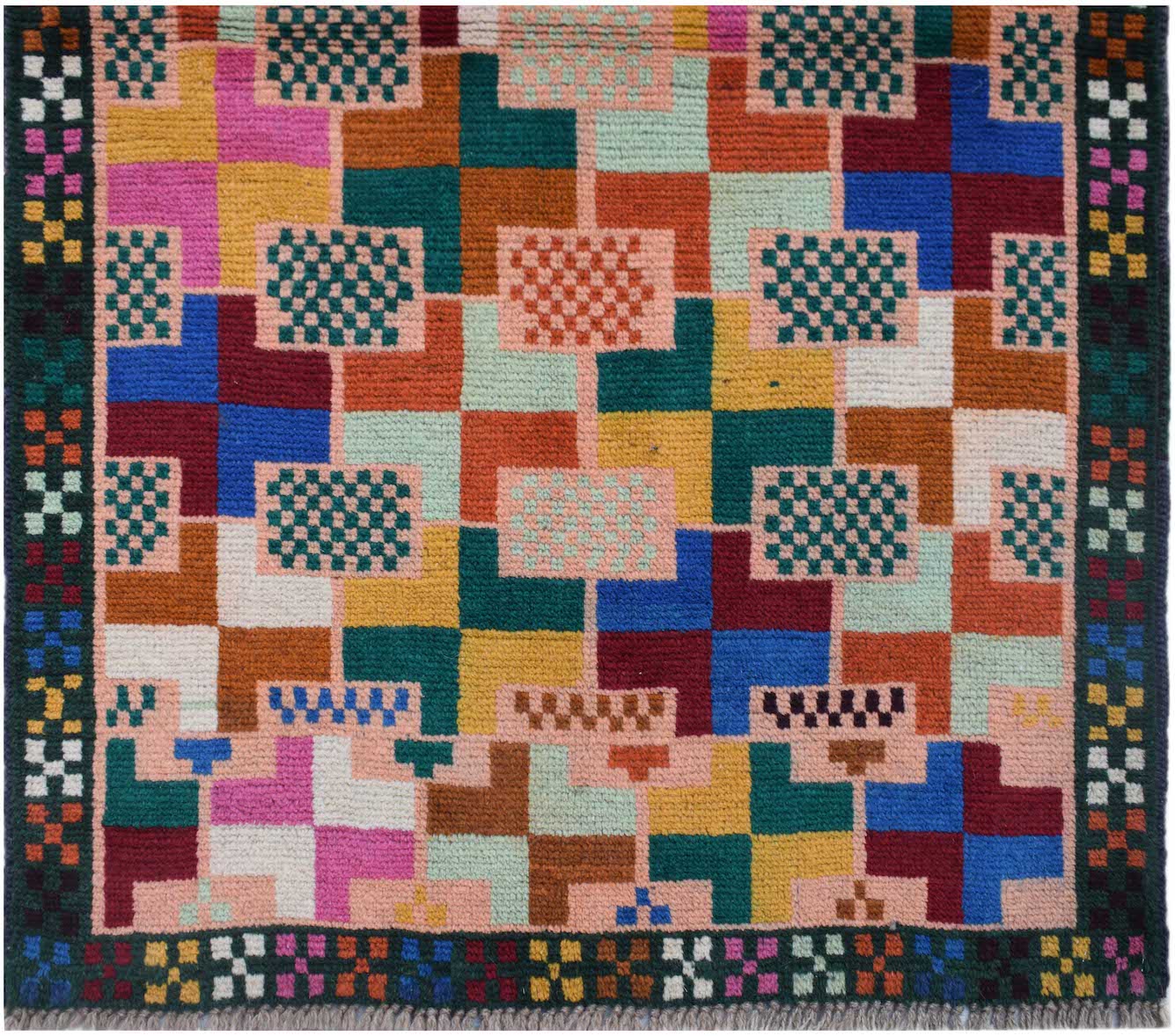 Handmade Afghan Pashm rug featuring a colorful geometric grid pattern on a light pink background.