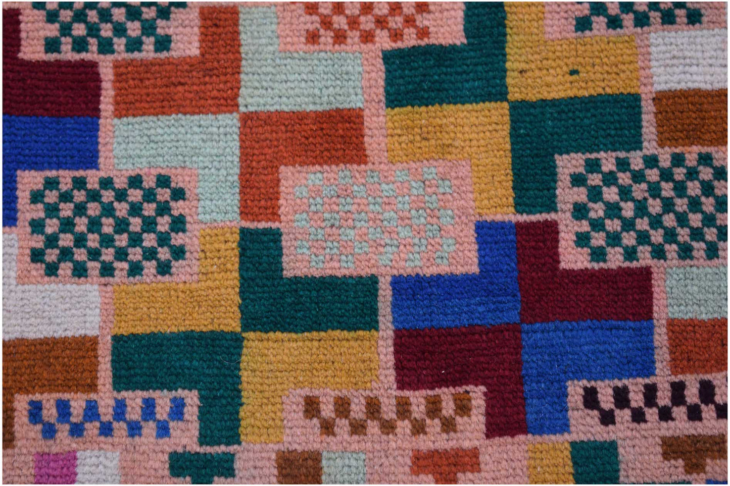 Handmade Afghan Pashm rug featuring a geometric pattern of colorful squares and checkered blocks.