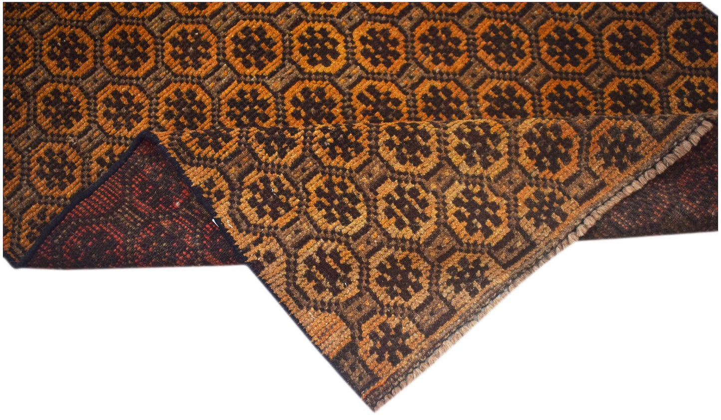 Handmade Afghan Baluch rug featuring a repeating geometric pattern in shades of brown and orange.