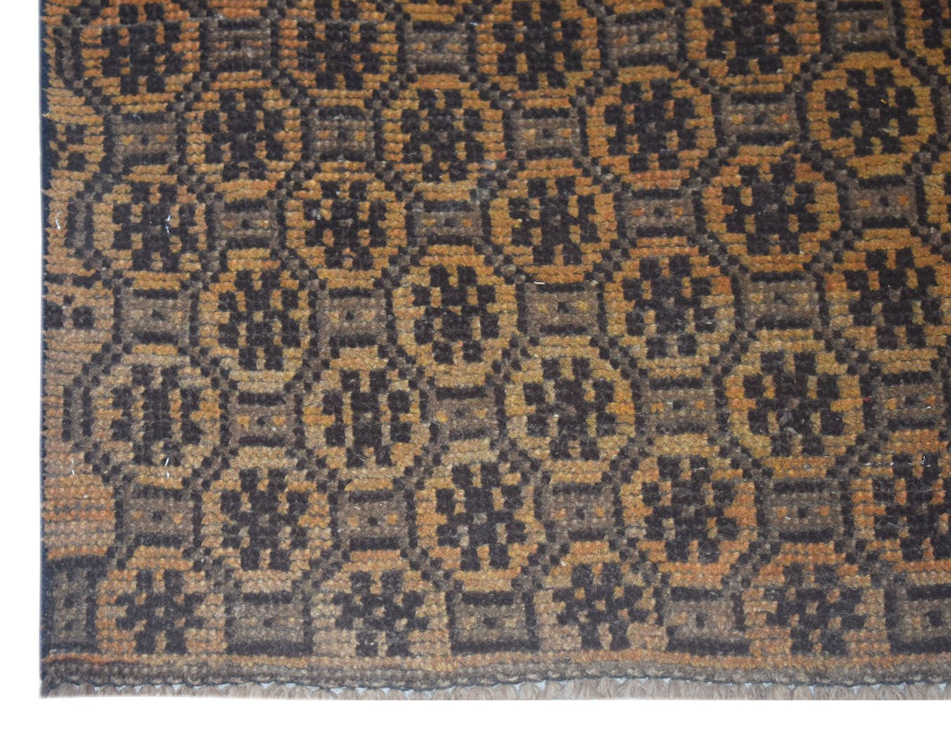 Handmade Afghan Baluch rug featuring a repeating geometric floral pattern in brown and tan wool.