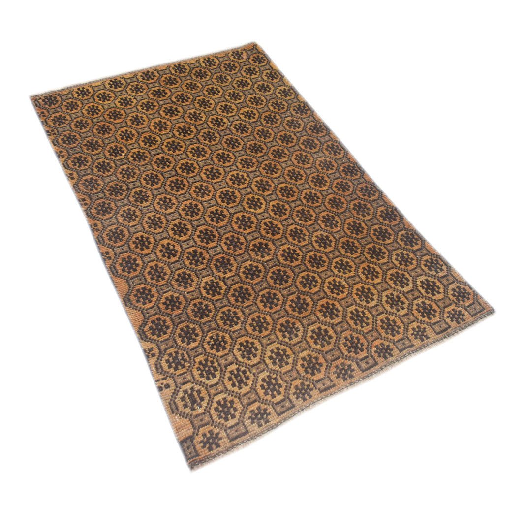A rectangular Afghan Baluch rug featuring a repeating geometric pattern in shades of brown and orange.