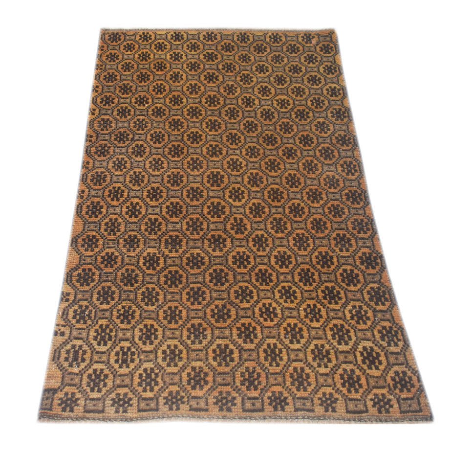 Handmade Afghan Baluch rug featuring a repeating geometric floral pattern in brown and tan wool.