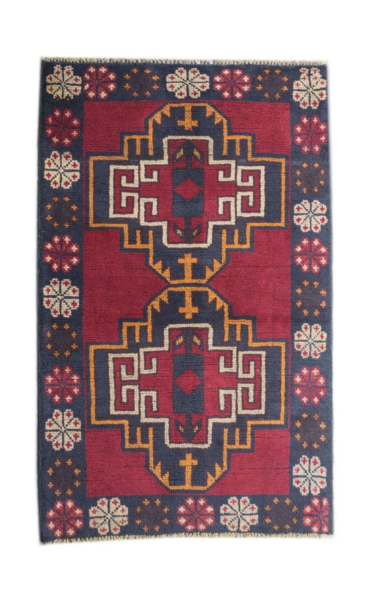Handmade Afghan Pashm rug featuring two geometric medallions in dark red, blue, and ivory wool.