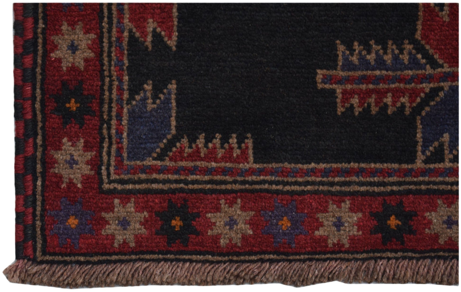A handmade Afghan Baluch rug featuring a dark field with geometric patterns and a red border.