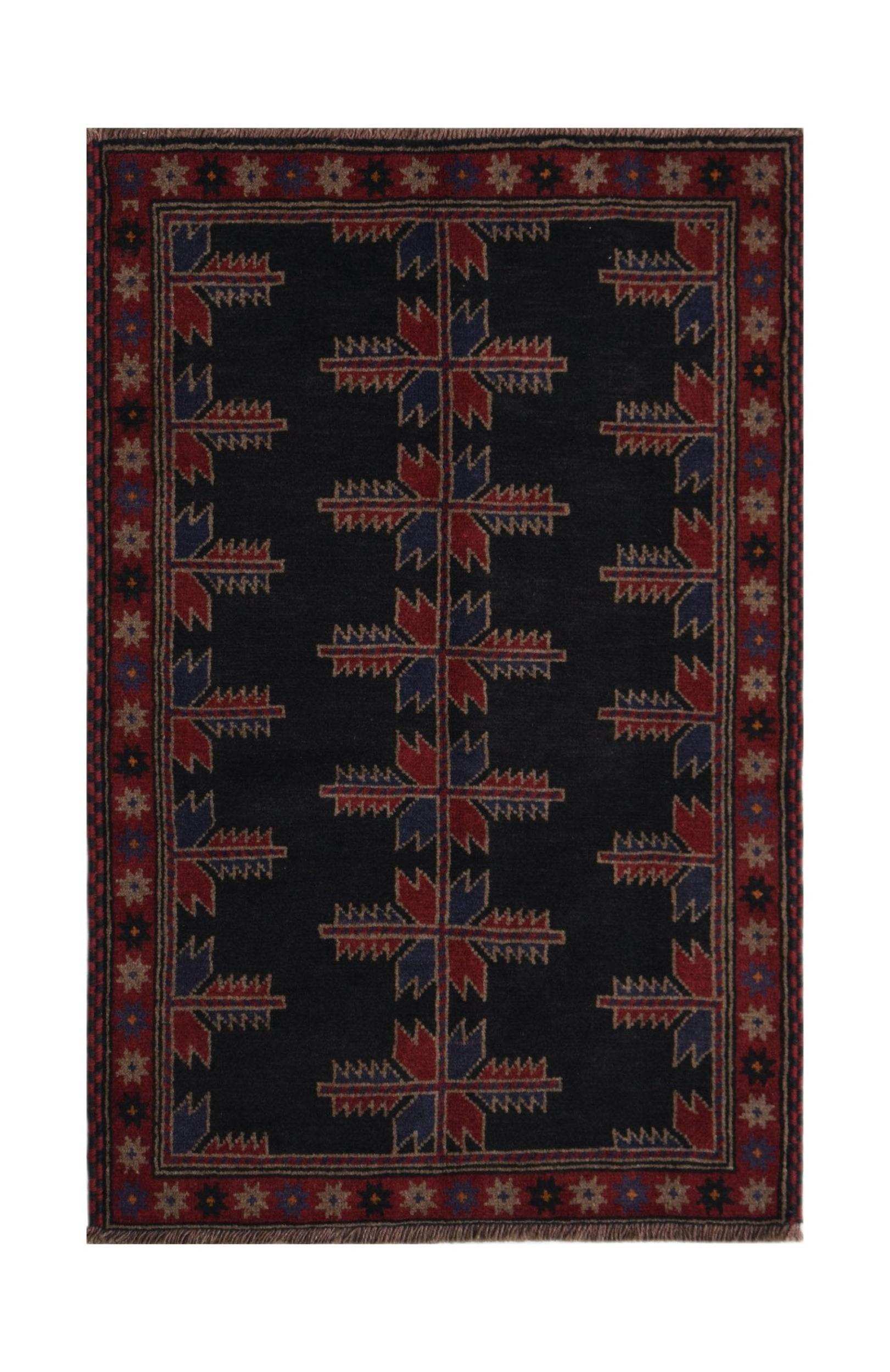Handmade Afghan Baluch rug featuring a dark field with repeating geometric floral motifs.