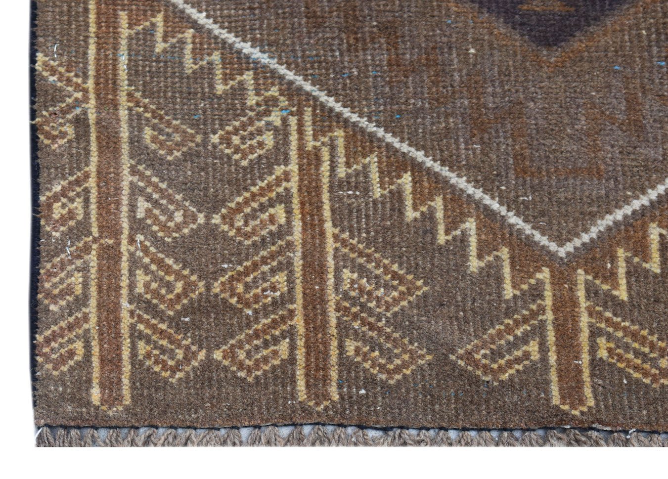 A handmade Afghan Baluch rug featuring geometric patterns in brown and tan wool.