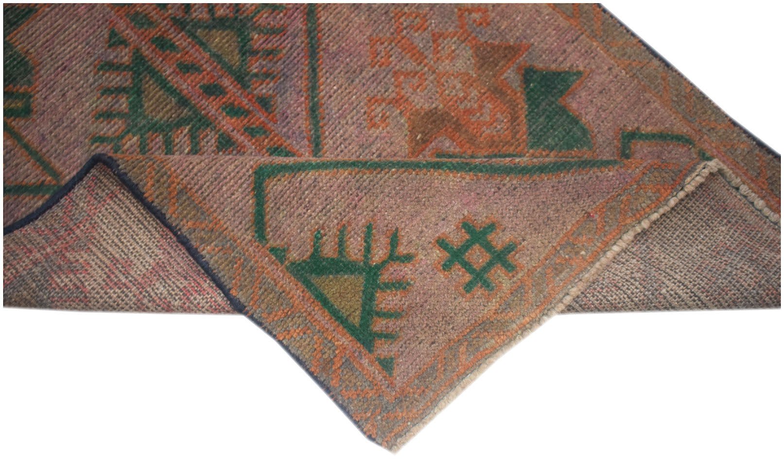 A handmade Afghan Baluch rug featuring geometric patterns in muted pink, green, and orange tones.