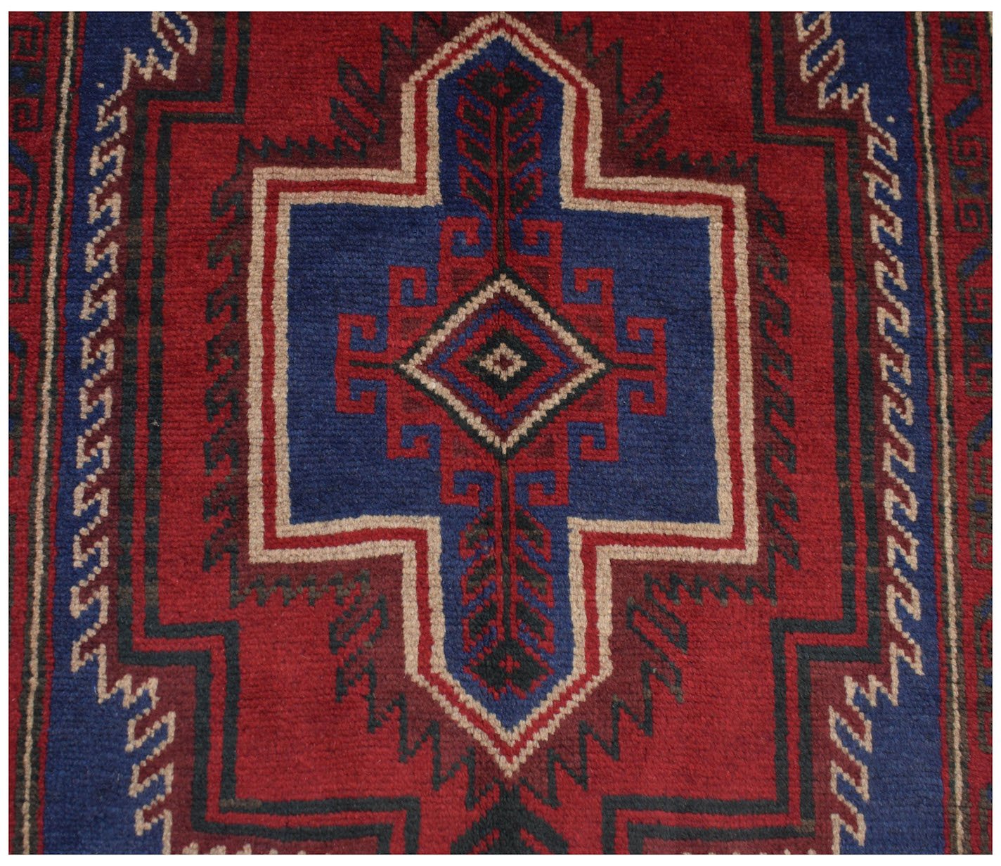 Handmade Afghan Baluch rug featuring a geometric central medallion in red, blue, and ivory wool.