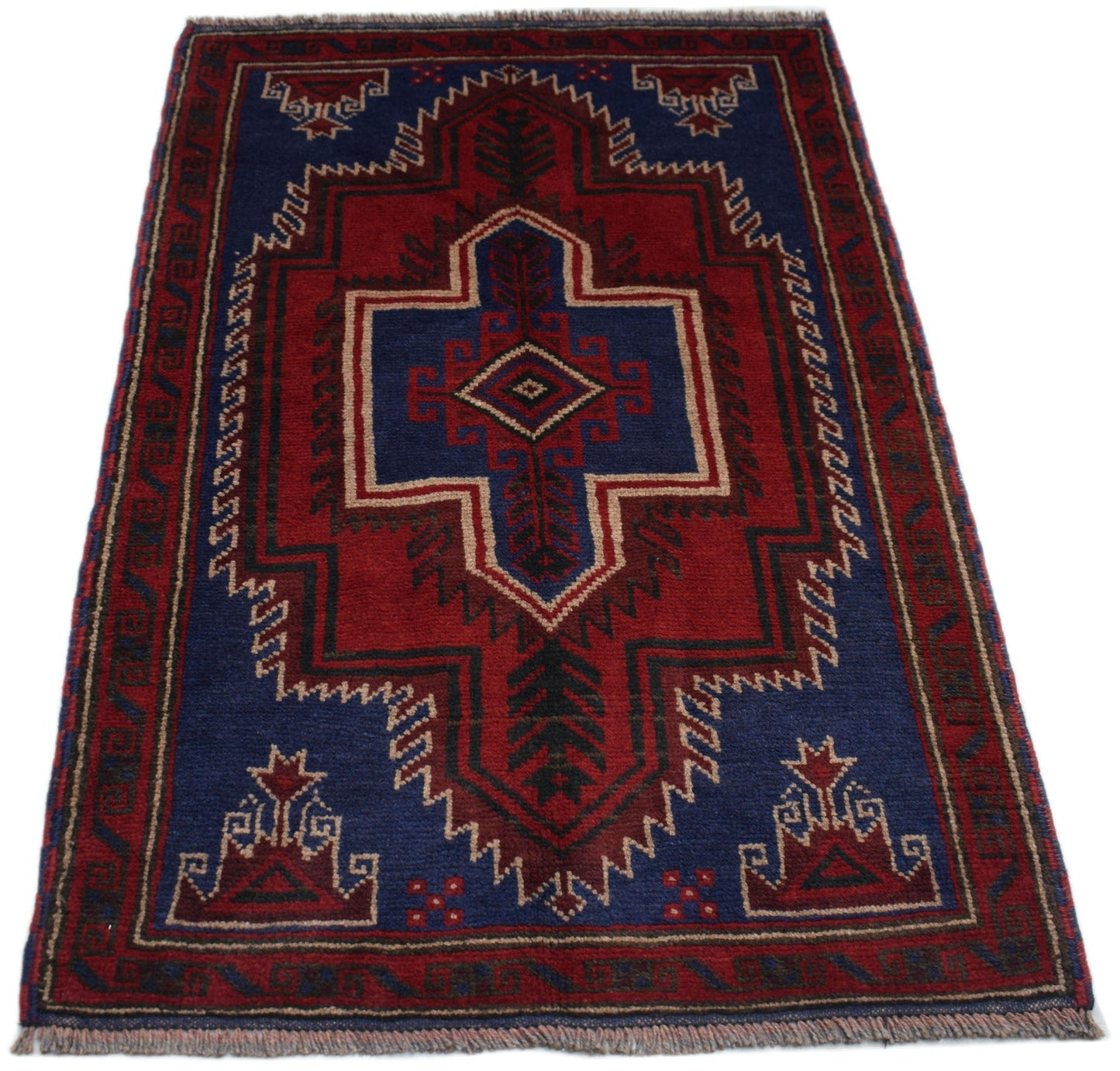 Handmade Afghan Baluch rug featuring a geometric tribal pattern in deep red, blue, and ivory.