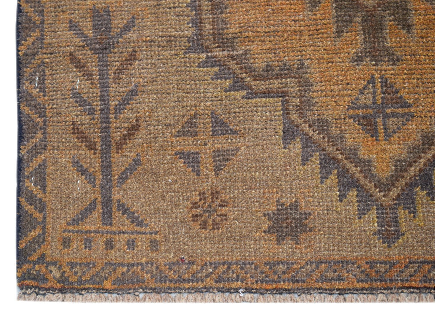 A handmade Afghan Baluch rug featuring geometric patterns in shades of brown and orange.