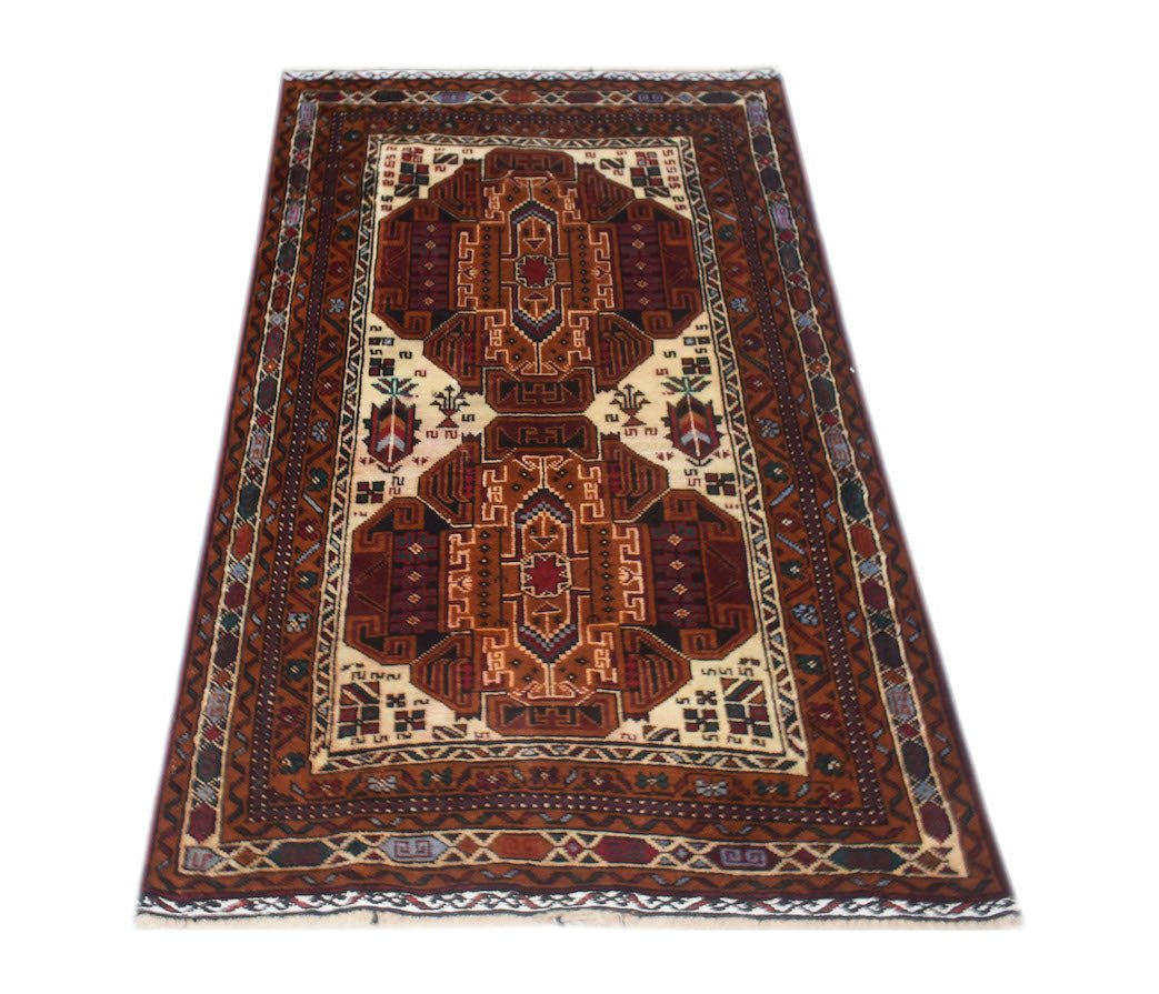 A handmade vintage Afghan Baluch rug featuring a geometric pattern in deep red and cream tones.