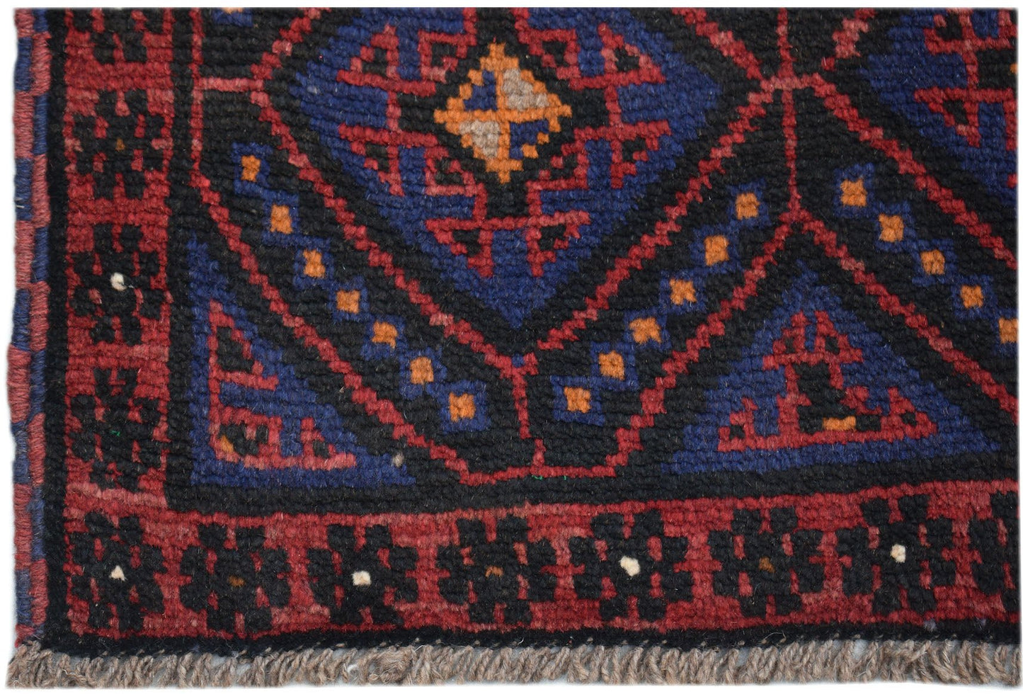 Handmade Afghan Baluch rug featuring a geometric diamond pattern in dark red, blue, and black.