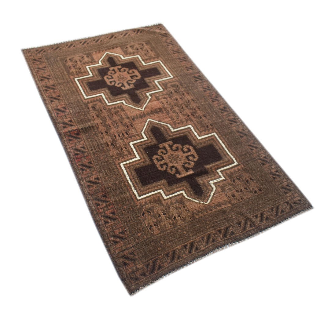 Handmade Afghan Baluch rug featuring two dark brown geometric medallions on a brown wool field.