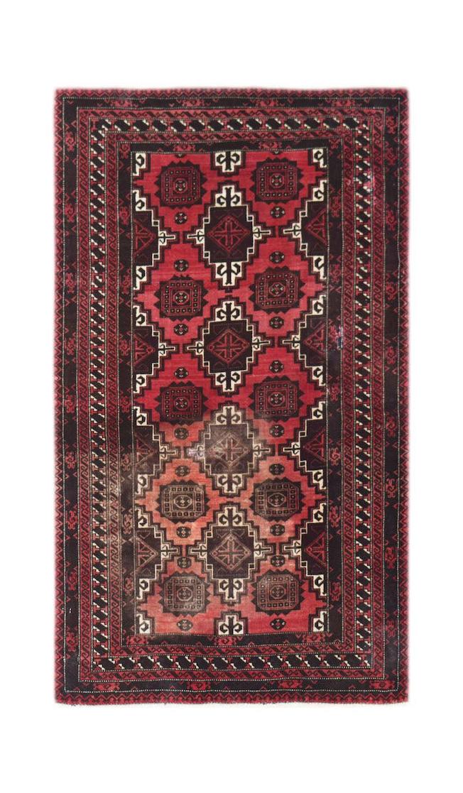 A handmade vintage Afghan Baluch rug featuring a geometric pattern in shades of red and black.