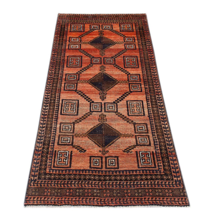 Handmade Afghan Baluch runner rug featuring geometric diamond patterns in shades of red and brown.