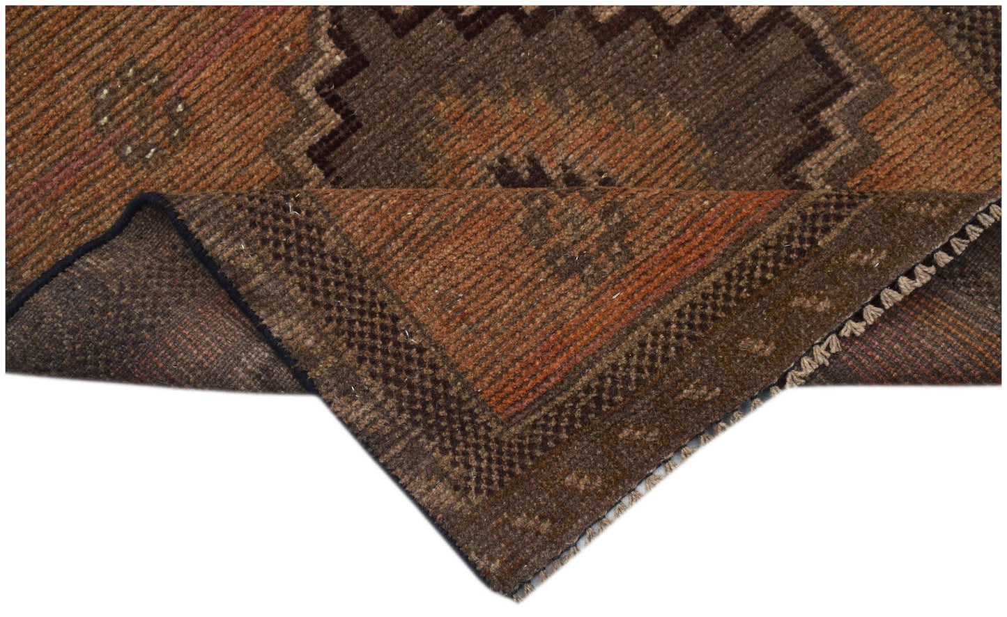 A handmade Afghan Baluch rug featuring a geometric brown and orange pattern with a folded corner.