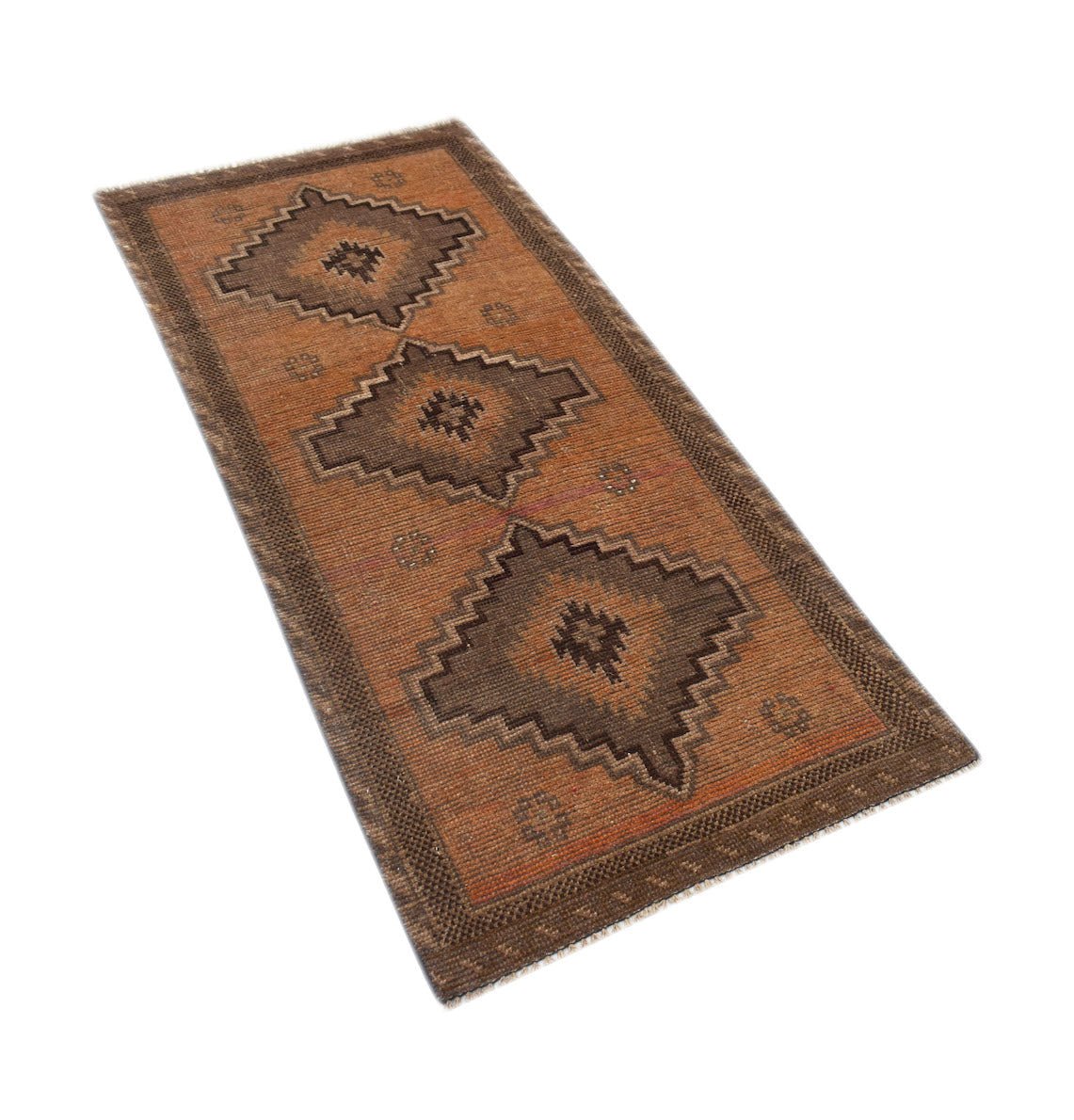 A handmade Afghan Baluch runner rug featuring three dark geometric medallions on a rust field.