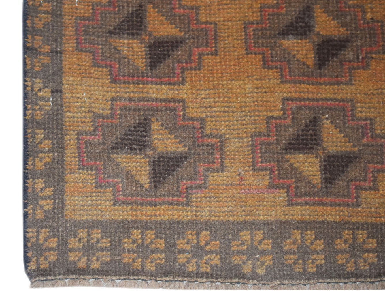 Handmade Afghan Baluch rug featuring a geometric pattern in shades of brown and gold.