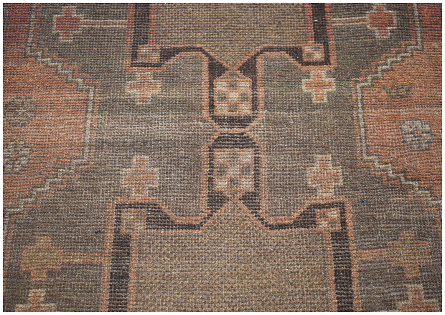 Handmade Afghan Baluch rug featuring a geometric pattern in shades of brown and terracotta.