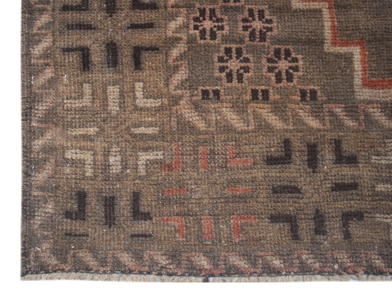 A handmade Afghan Baluch rug featuring geometric patterns in shades of brown, tan, and rust.