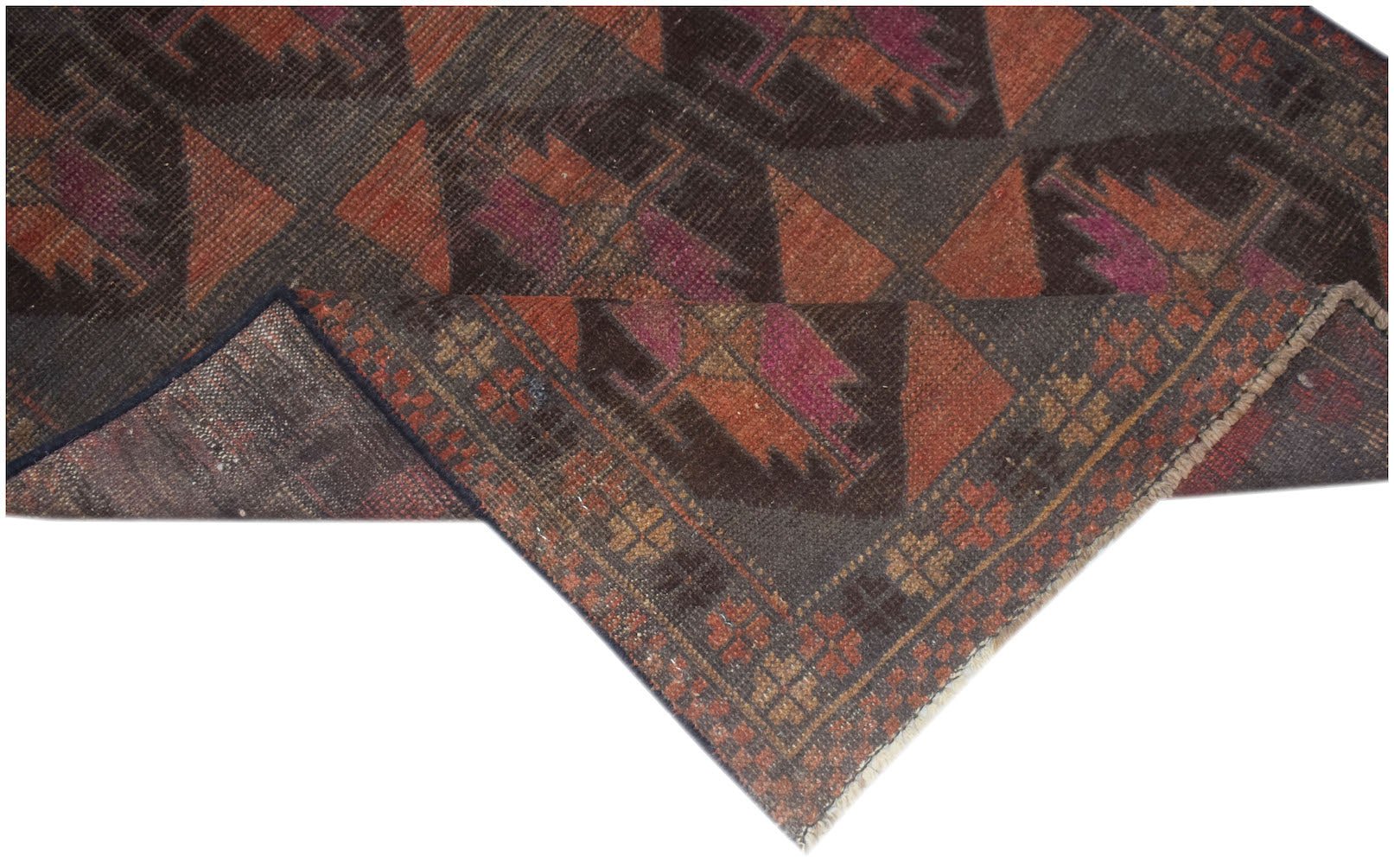 A handmade Afghan Baluch rug featuring geometric patterns in shades of brown, orange, and magenta.