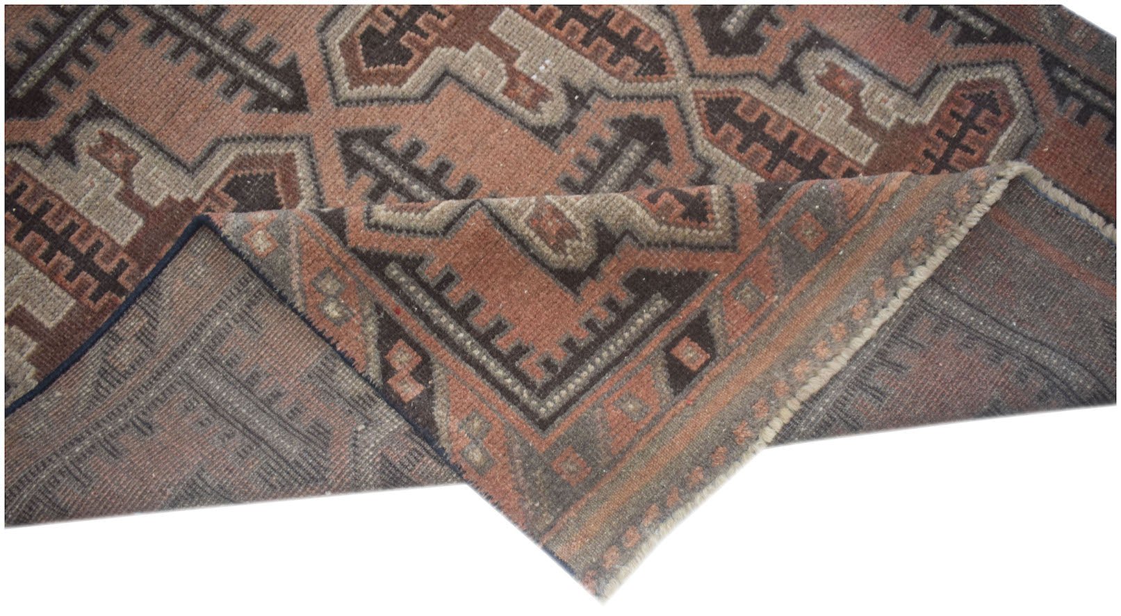 A handmade Afghan Baluch rug featuring geometric patterns in shades of brown and terracotta.