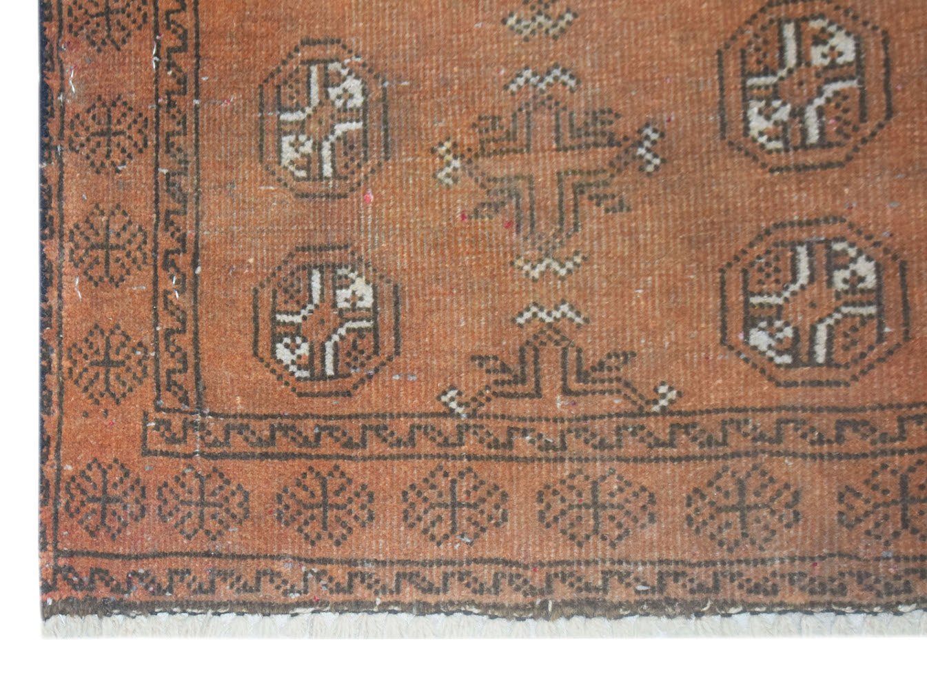 Handmade Afghan Baluch rug featuring geometric motifs in shades of orange and dark brown.