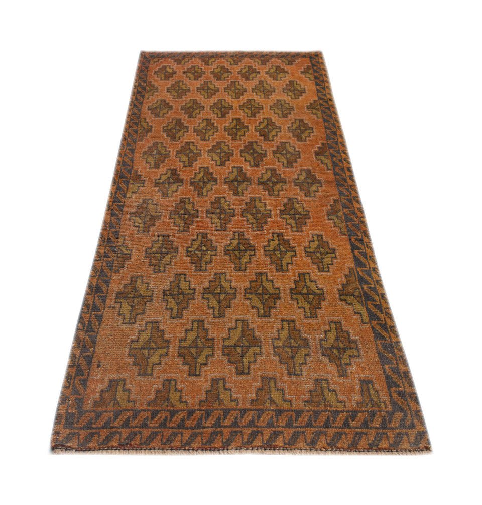 An Afghan Baluch rug featuring a repeating geometric pattern in orange and dark brown wool.